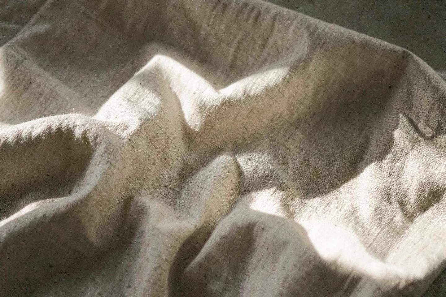 Softly draped natural linen in warm daylight
